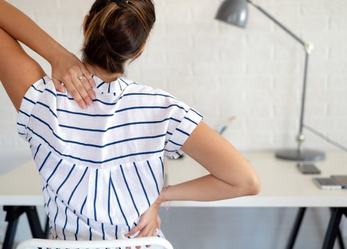 Woman with back pain at work