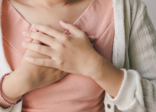 Woman touching her cardiovascular area