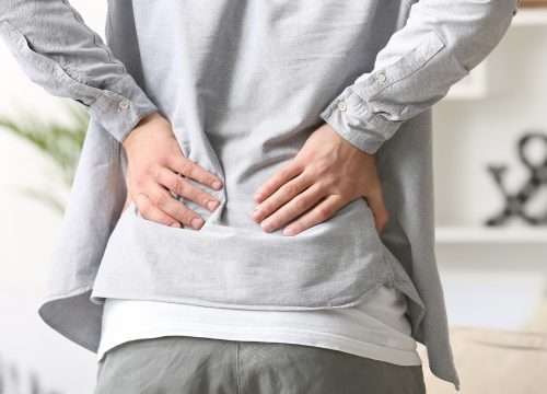 Man clutching his back in pain