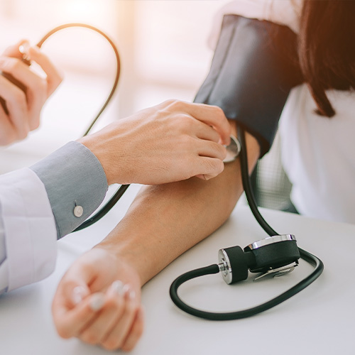 doctor taking blood pressure on a patient